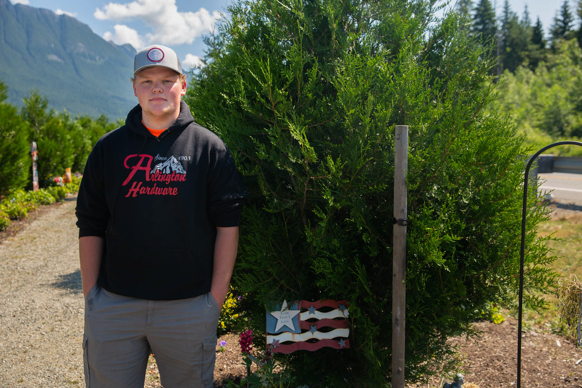 Quinton Kuntz - Quinton Kuntz stands by a tree planted in memory of his great-aunt, one of 43 residents of Oso, Washington, who died in a landslide. Kuntz was in high school at the time and missed the slide by a few hours because his baseball team had a game. (Allie Barton/News21)