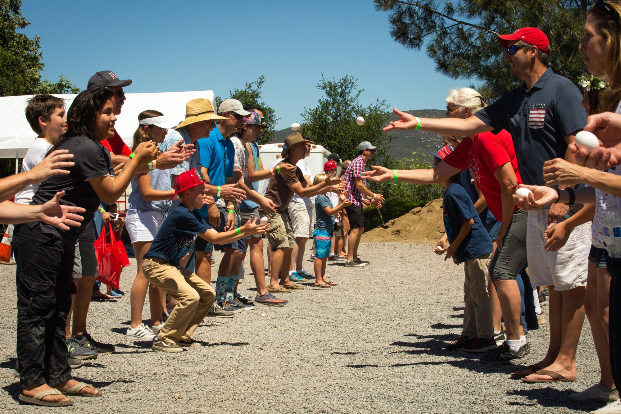 Residents of Elfin Forest and Harmony Grove, California, participate in an egg toss during the towns’ 42nd annual Fourth of July parade and picnic. (Kailey Broussard/News21)