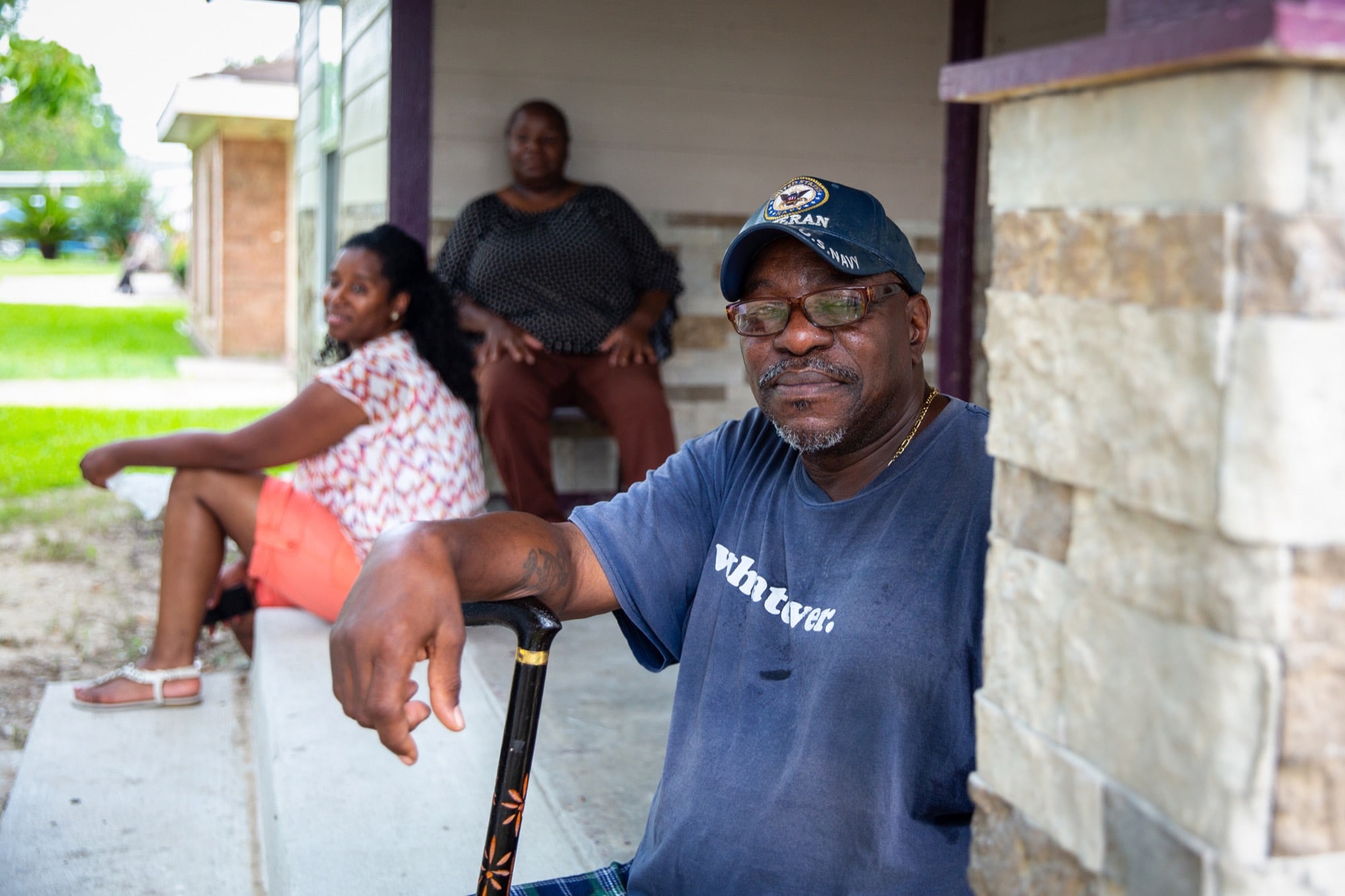 Forrester Johnson and his wife, Timeka (center), lived in a handicap-accessible FEMA trailer for 18 months after Hurricane Harvey hit Port Arthur, Texas. They moved back into their unfinished home when their lease of the trailer ended and FEMA began charging $750 a month for rent. Johnson now owes $1,500 he doesn't have because all their money has gone to rebuilding the house. (Stacy Fernández/News21)