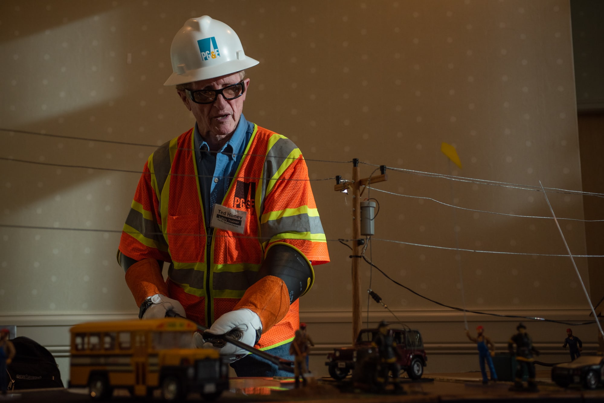 Ted Honey, a safety trainer of Pacific Gas & Electric, California's largest utility company, demonstrated the dangers of a downed power line at a PG&E open house in Redding, California. (Anton Delgado/News21)