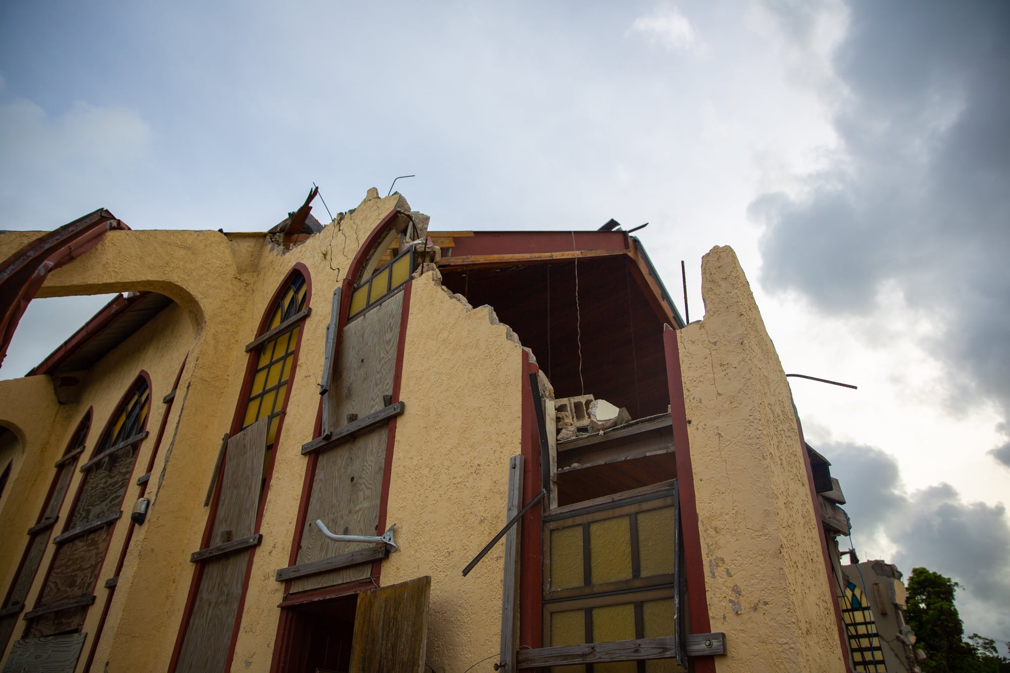 Hurricanes Irma and Maria ripped open the front of the Philadelphia Seventh-Day Adventist Church on St. Thomas, U.S. Virgin Islands. Worshippers gather  in the basement as they wait to rebuild two years later. (Ariel Salk/News21)