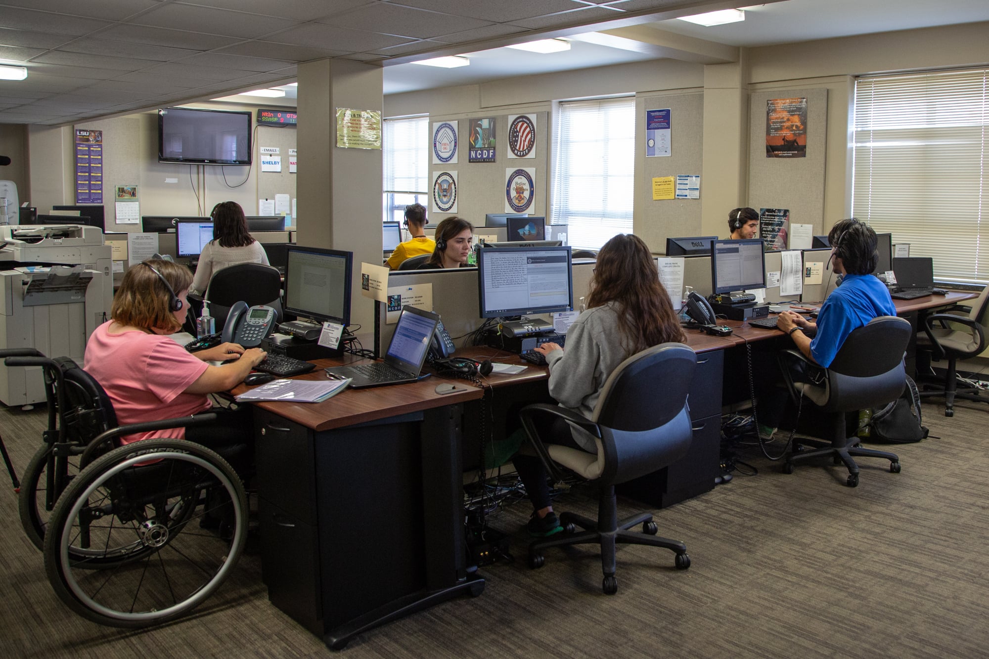 Students process disaster fraud complaints at the National Center for Disaster Fraud, which is headquartered in Baton Rouge, Louisiana. Losses to disaster fraud are estimated at 10% of disaster-related insurance payouts and FEMA spending. (Natalie Anderson/News21)