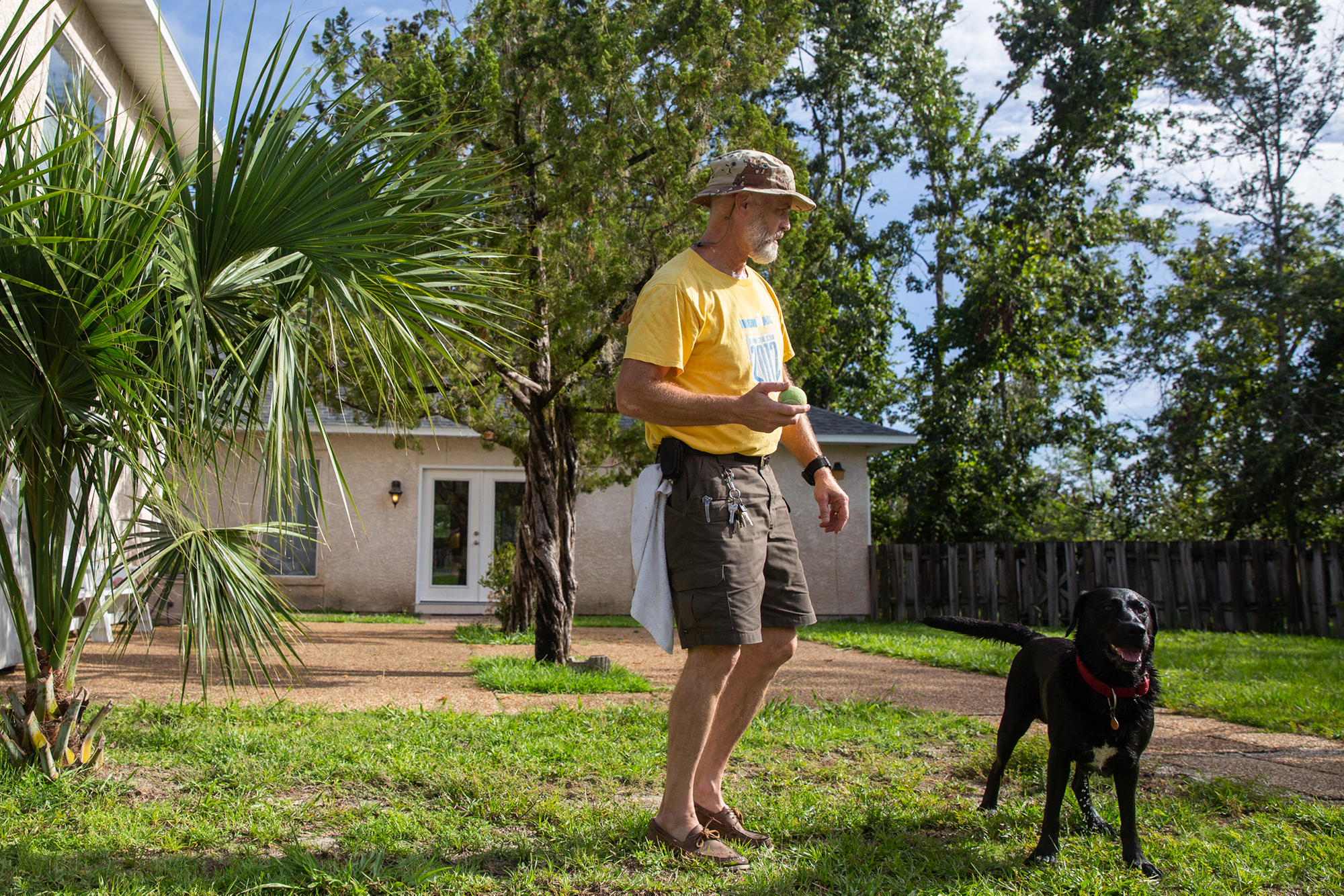 Ted Mahoney and his dog, Sadie, rode out Hurricane Michael in October 2018. His roof has been repaired but little has been done inside, even though Mahoney said his insuror paid a contractor for the work. (Stacy Fernández/News21)