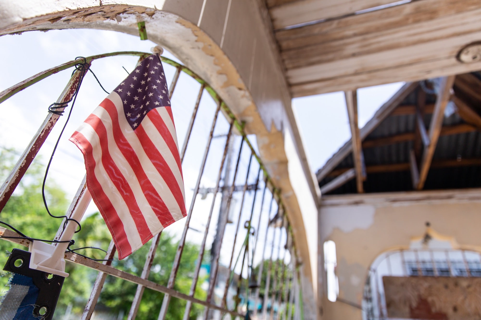 Old Glory waves from the Morales home in Santurce. About all that’s left of the house are four walls surrounding piles of debris. There is no roof; a neighbor’s generator supplies the power. (Ellen O'Brien/News21)