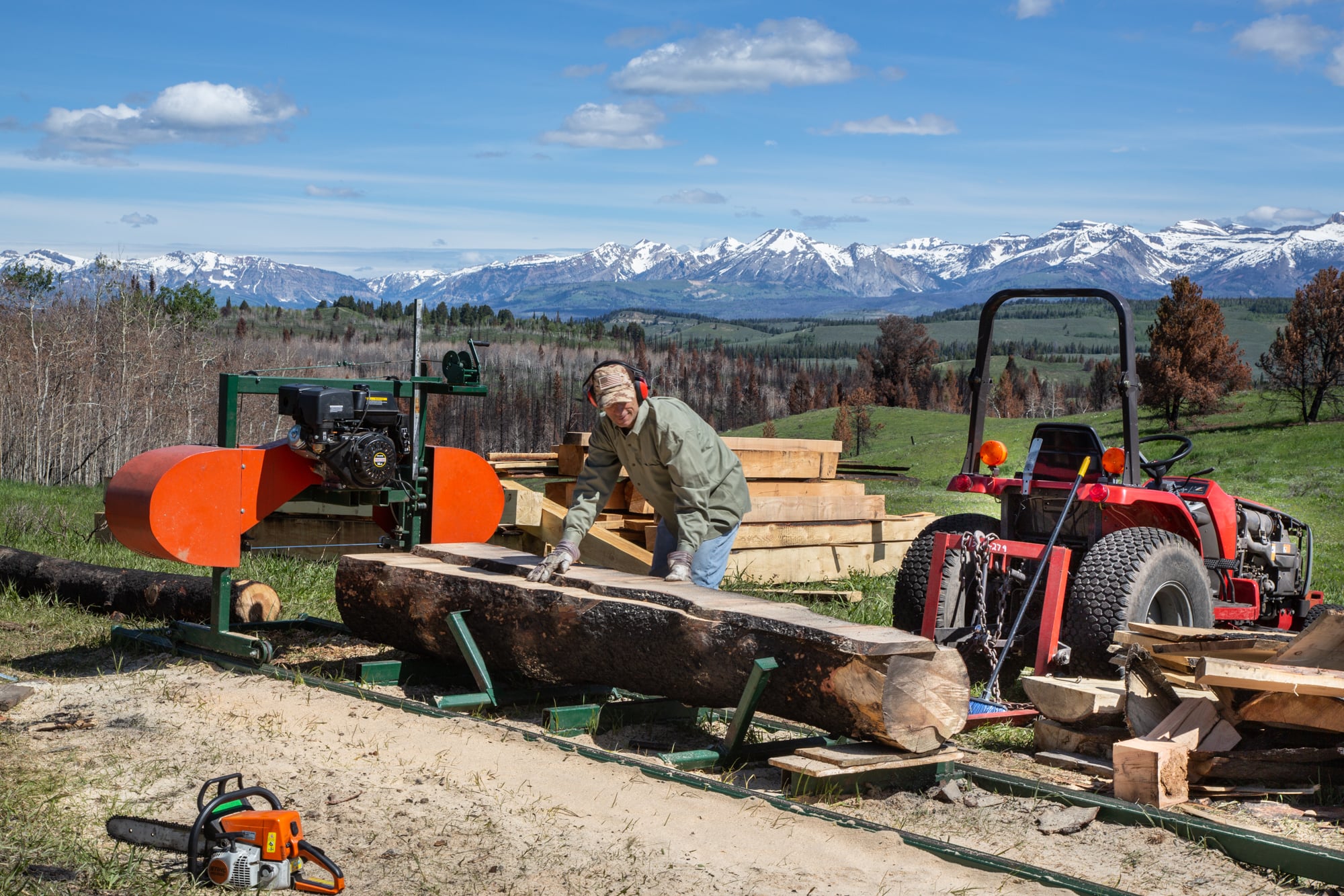 George Bolcato’s portable sawmill allows him to rebuild his home in Hoback Ranches using lumber he cuts from logs that were not badly burned.(Bailey Lewis/News21)