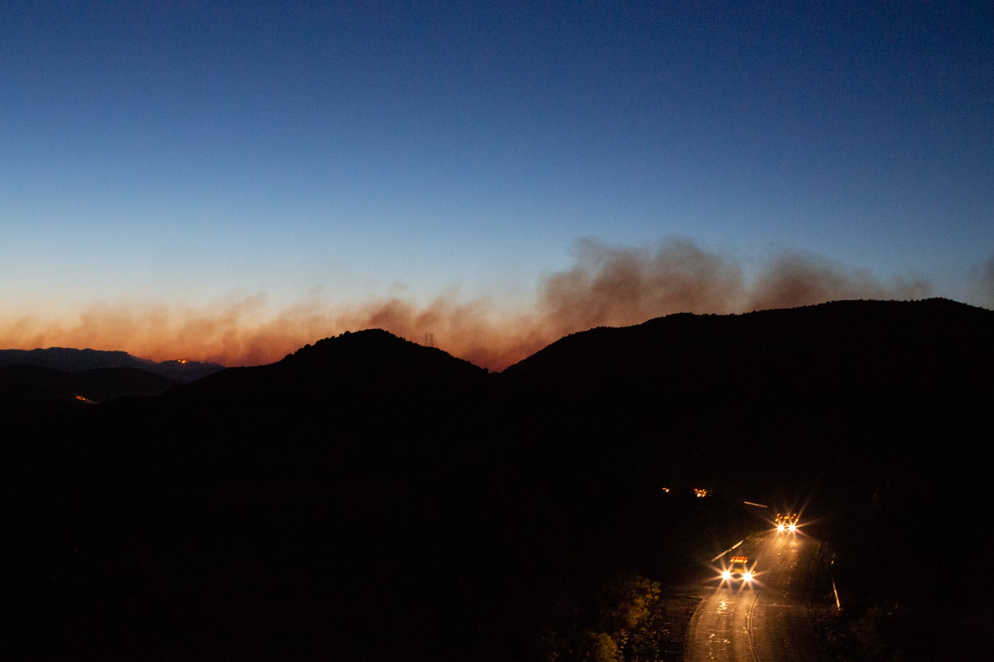 Hotshot crews return to their camps as smoke from the Woodbury Fire rises over the Superstition Wilderness in central Arizona. (Anton L. Delgado/News21)